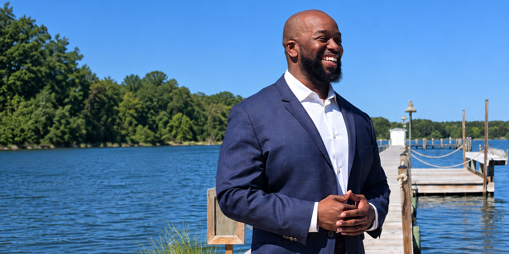 Campaign portrait of BJ Hall beside the water in a navy jacket